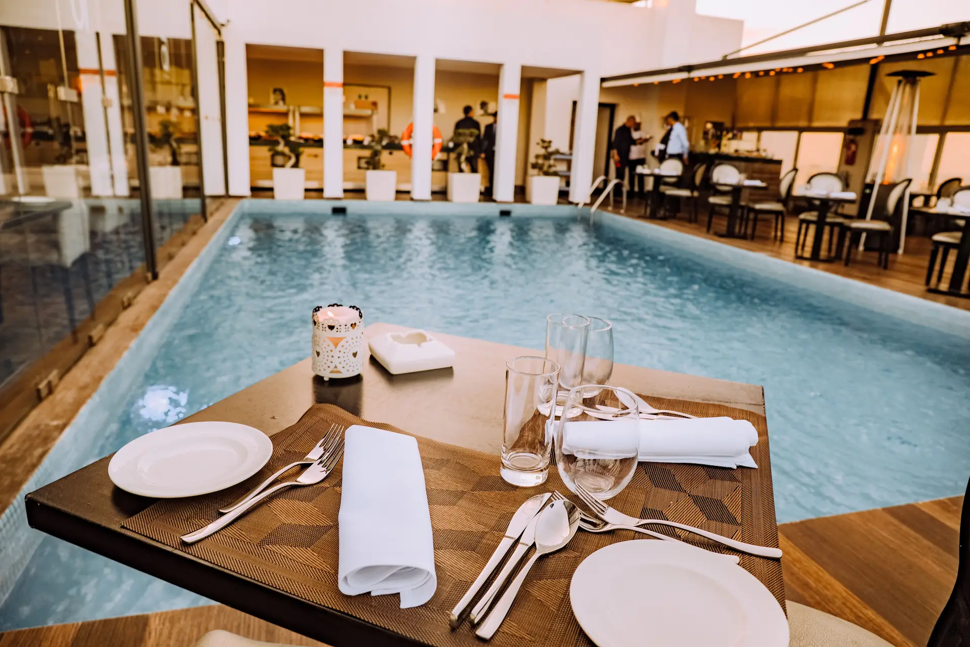 Restaurant table set beside the pool